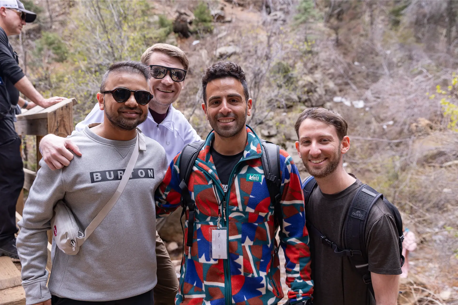 Executives sharing conversation beside a mountain trail