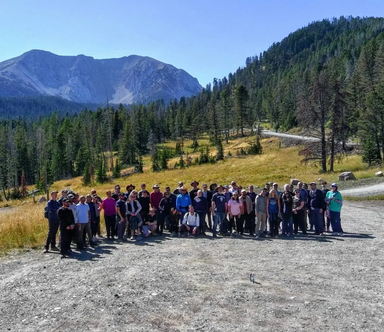A large group of CISO Ascent members on a mountain trail