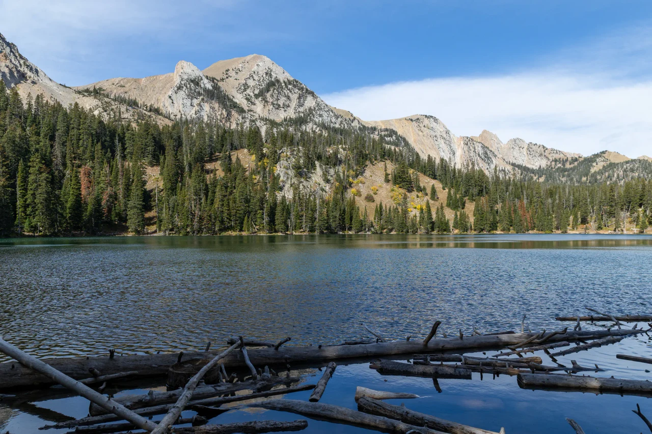 An alpine lake beneath forested mountain peaks in Montana's Yellowstone country